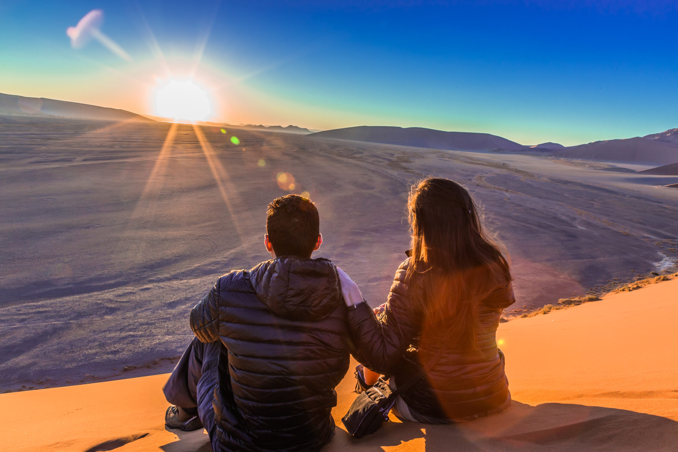 Couple on sand dune in desert during sunrise. Sossusvlei, Namib Namibia is one of the best places to propose in Africa