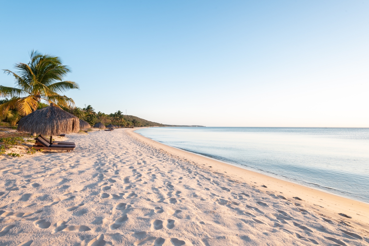 Anantara-Bazaruto-Island-Resort-beach-view-at-sunset White sandy beach fringed with palm trees
