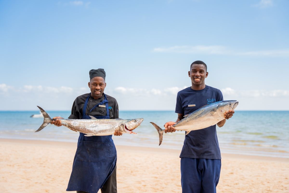 azura-benguerra-fishing Smiling staff holding two massive fish
